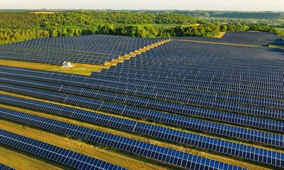 Aerial footage begins with a slow, sweeping drone shot that glides over a vast solar farm, capturing the intricate patterns of solar panels arranged in rows. Generated with ai