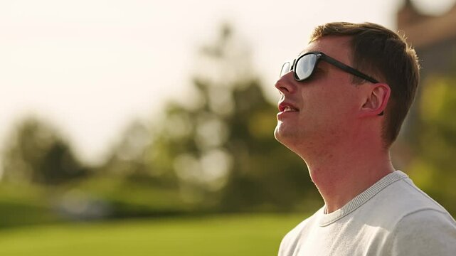 A man looks at the sky at the model of an airplane he is driving.