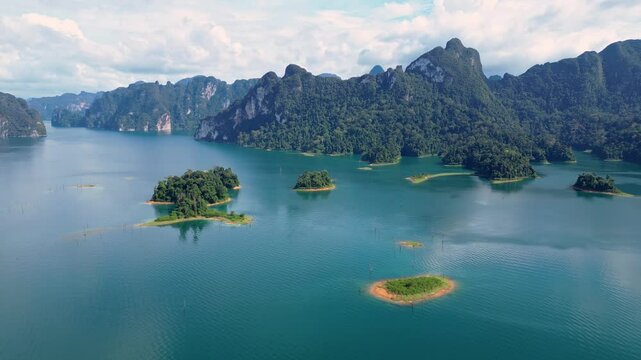 Khao Sok, Thailand: Aerial drone footage of the stunning Khao Sok dam lake famous for its karst and cliffs with small islands in the southern Thailand Surat Thani province.