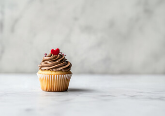 Vanilla cupcake muffin with a red heart on whipped mocha mousse on white background. Design template for love, sweets, poster, and cards for party, birthday and Valentine's day with place for text.