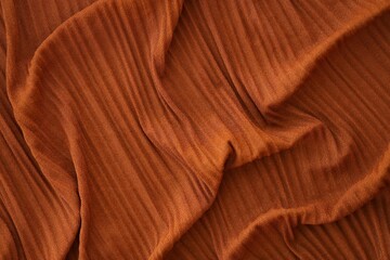 Bright orange fabric background from a piece of crumpled clothes