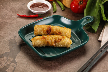 Vietnamese stuffed spring roll served sauce