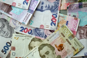 Big amount of different ukrainian hryvnia currency money bills in pile