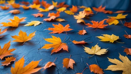 A bunch of orange and yellow leaves on a blue surface