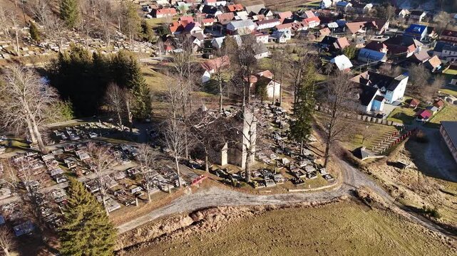 Aerial View of an Old Church in the Middle of a Cemetery in a Rural Landscape, zoom out