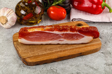 Piece prosciutto crudo over board