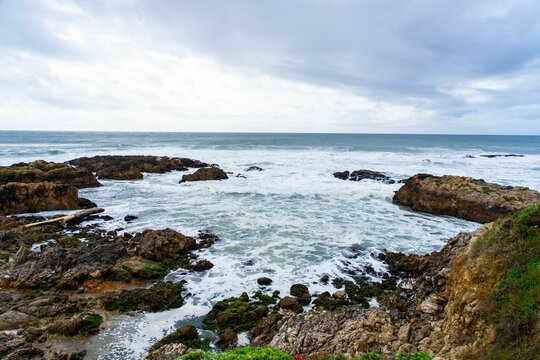 Scenic coastal view with rocky shoreline and ocean.