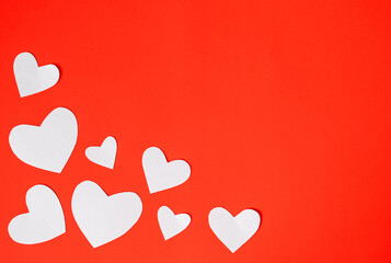 White paper hearts on red background for happy valentines day