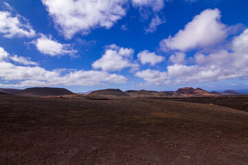 Extensive plains before the sea amid volcanoes