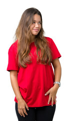 Fototapeta premium Young beautiful brunette woman wearing red t-shirt over isolated background looking away to side with smile on face, natural expression. Laughing confident.