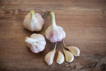 Garlic on wooden background, healthy food and nutrition, vintage style