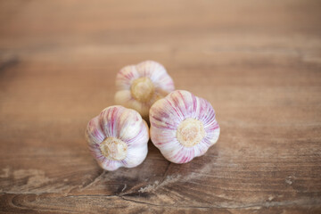 Garlic on wooden background, healthy food and nutrition, vintage style