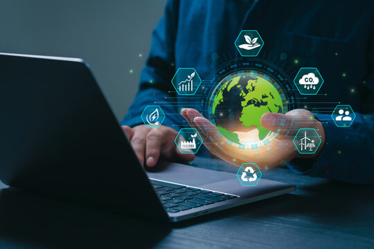 Businessman analyze sustainability investment and holding green globe. Concept of ESG, Green businesses, Net zero, Green energy, Carbon neutral, Green technology, Carbon credit. CSR. Climate change.