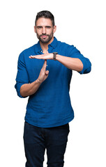 Young handsome man over isolated background Doing time out gesture with hands, frustrated and...