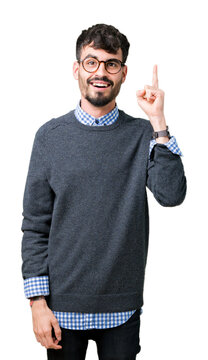 Young handsome smart man wearing glasses over isolated background pointing finger up with successful idea. Exited and happy. Number one.