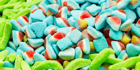 Assortment of delicious colorful gummy chewy candies. Top view. Close-up of colorful jelly candy