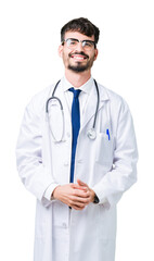 Fototapeta premium Young doctor man wearing hospital coat over isolated background Hands together and fingers crossed smiling relaxed and cheerful. Success and optimistic