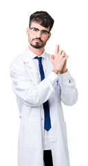 Young professional scientist man wearing white coat over isolated background Holding symbolic gun with hand gesture, playing killing shooting weapons, angry face