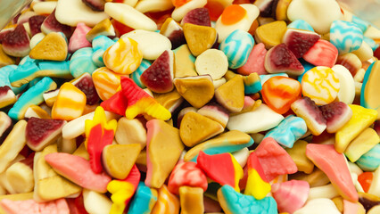 Assortment of delicious colorful gummy chewy candies. Top view. Close-up of colorful jelly candy