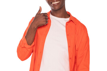 Person in orange shirt gives thumbs up while smiling brightly in a cheerful setting