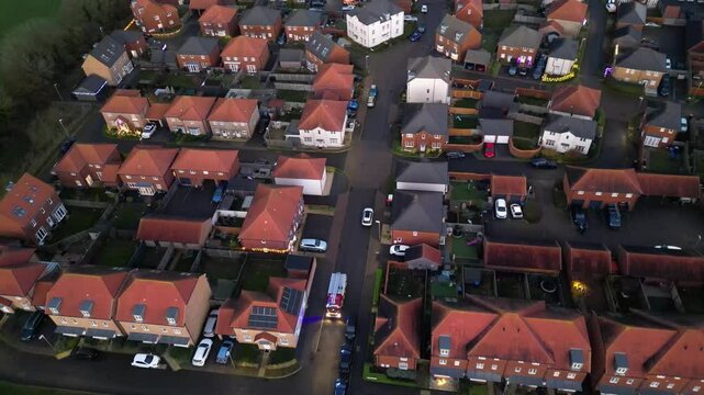 Following a fire engine with its blue lights on as it travel through a street in Aylesham, Kent, UK