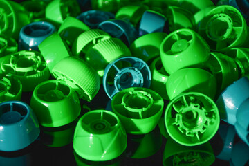 Plastic bottle caps. Green lids from plastic bottles. Recycling collection and processing plastic...