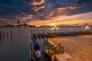 The most popular and romantic place in Venice. Gondolas moored at St. Mark's Square with the Church...