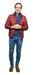 Obraz premium Middle age handsome man wearing glasses and winter coat Hands together and fingers crossed smiling relaxed and cheerful. Success and optimistic