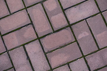 Closeup of pink concrete pavement with double basketweave layout