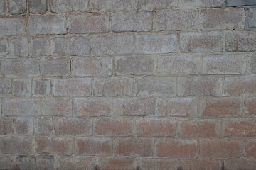 Uneven surface of whitewashed wall made of concrete masonry units