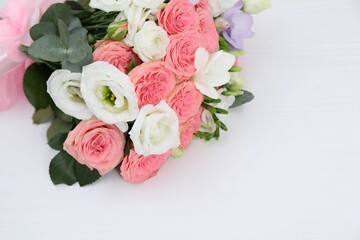 Beautiful wedding bouquet on white table, above view. Space for text