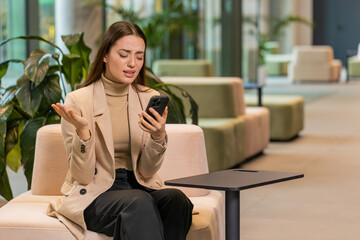 Caucasian young businesswoman girl using smartphone typing browsing, loses becoming surprised...