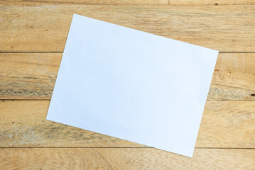 A sheet of white paper on a wooden board