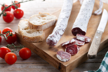 Fuet.Dry cured fuet sausage on wooden table