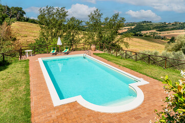 pool in country house surrounded by nature on a sunny summer day 