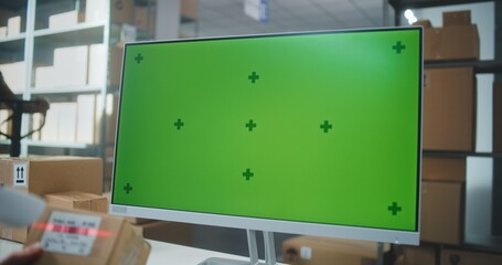 Female Warehouse Associate Scans Code on Cardboard Box with Scanner, Enters Parcel Information on Computer, Works in Delivery Service. PC Screen Shows Green Screen Chroma Key Template. Handheld.