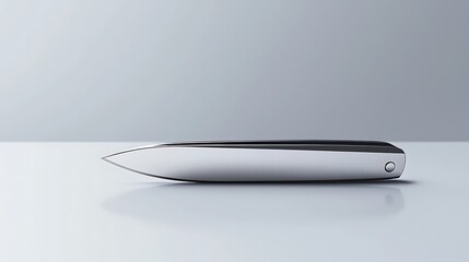 A silver knife is laying on a table