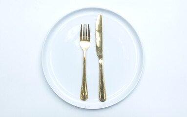 Sophisticated table setting with fork, spoon, and ceramic plate for dining decor ideas.