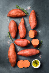 Raw organic sweet potatoes. Vertical photo, top view, close-up.
