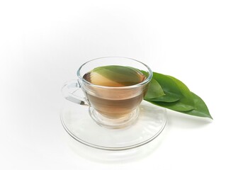 Soursop leaf boiled water in glass on white background. Top view angle setup. Healthy drink lifestyle 