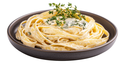 A plate of creamy alfredo fettuccine pasta topped with fresh herbs like parsley and basil, served on a pristine white plate. This homemade dish offers an elegant take on classic Italian cuisine.