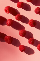 Vibrant Fresh Raspberries on a Pink Background with Bold Shadows