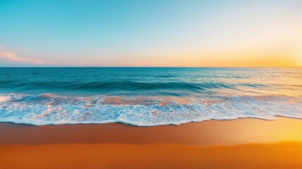 Obraz premium Serene beach view with gentle waves and golden sand under a colorful sunset sky.