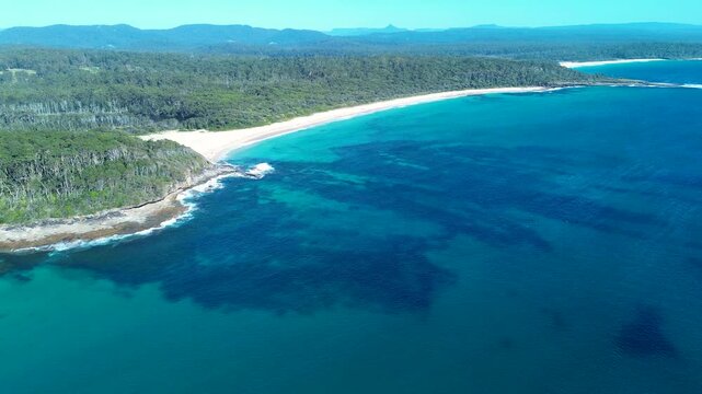 Drone aerial landscape of Bawley Point North Beach ocean sea coastline headland with bushland forest South Coast Australia outdoors environment reef tourism travel