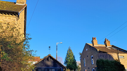 Fototapeta premium Aerial view of English countryside village with charming tiled rooftops.