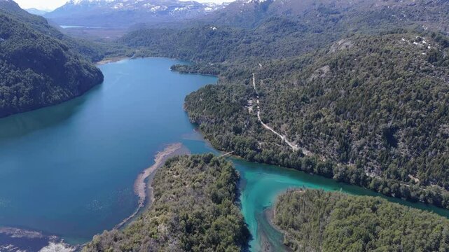 Drone fly above Patagonian turquoise river Landscape over Green lush mountains of Argentina