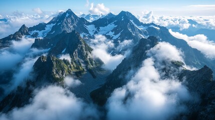 Obraz premium Aerial view Mountain peaks shrouded in clouds at sunrise, scenic backdrop
