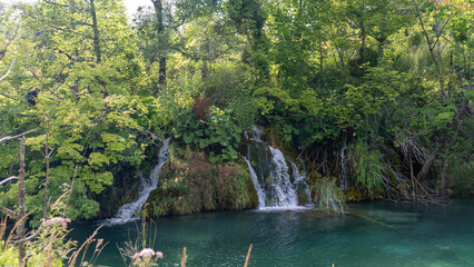 Transparent Turquoise Colored Waters of the Lake Are Having Ripples. Many Small Waterfalls Flowing Into the Lake. Plitvice Lakes, National Park, Croatian Scenery, Waterfall Views, Natural Beauty