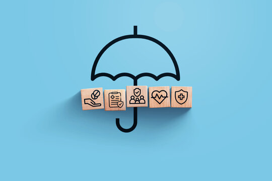 insurance, creative idea. Wooden blocks with icons of medical insurance with umbrella on blue background, top view. Health and insurance, concept