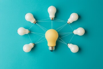 Obraz premium Workplace culture improvement concept. Central yellow light bulb surrounded by connected white bulbs on a teal background